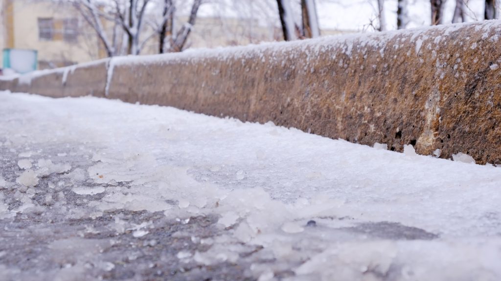 Ice on a concrete curb.